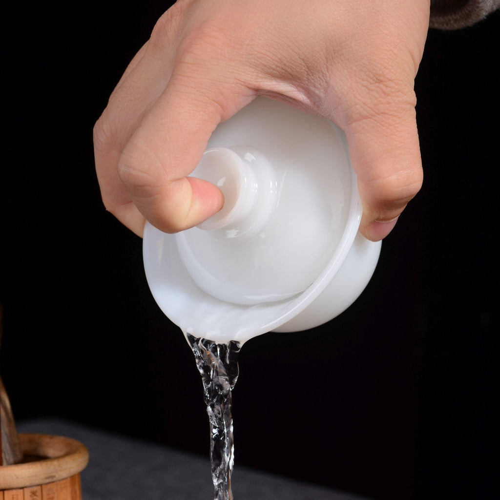 Dehua Yu Ci jade porcelain gaiwan pouring into a glass pitcher