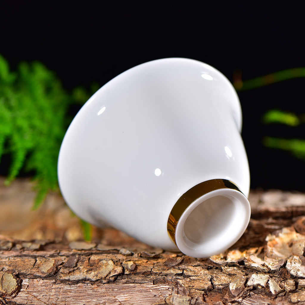 Bottom view of a Dehua jade porcelain gaiwan with gold foot ring