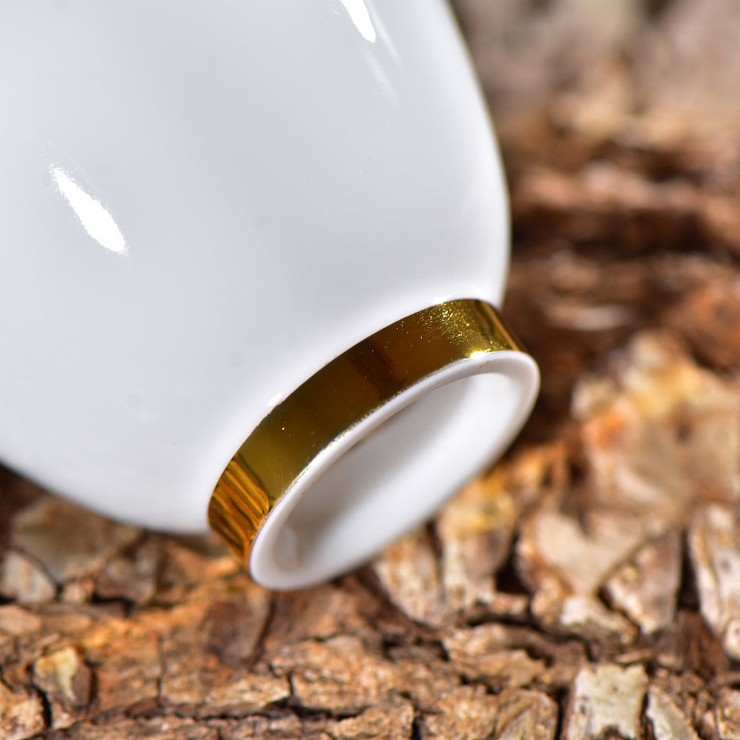 Close-up of the gold foot ring on a Dehua jade porcelain gaiwan