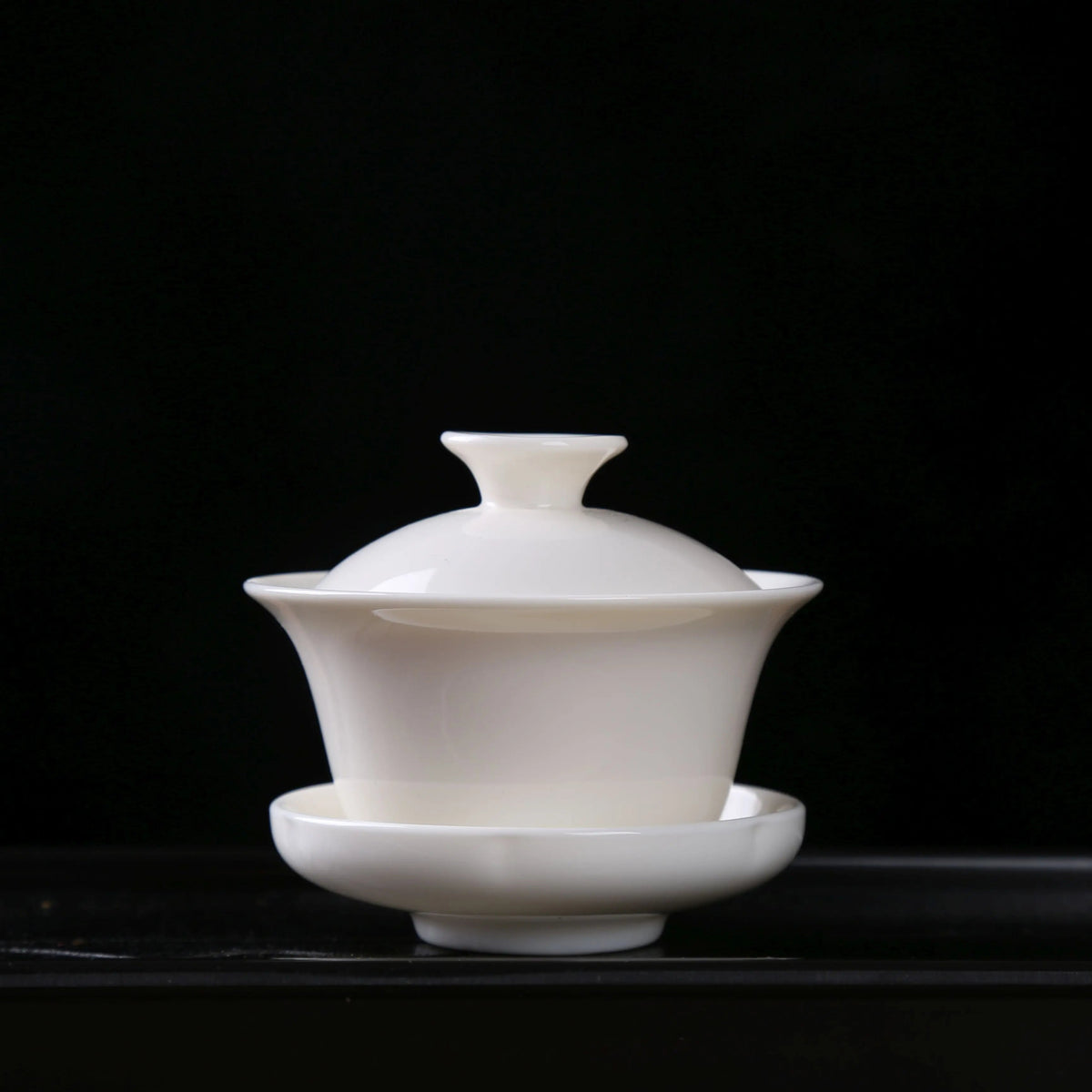 Front view of classic white porcelain gaiwan with lid and saucer