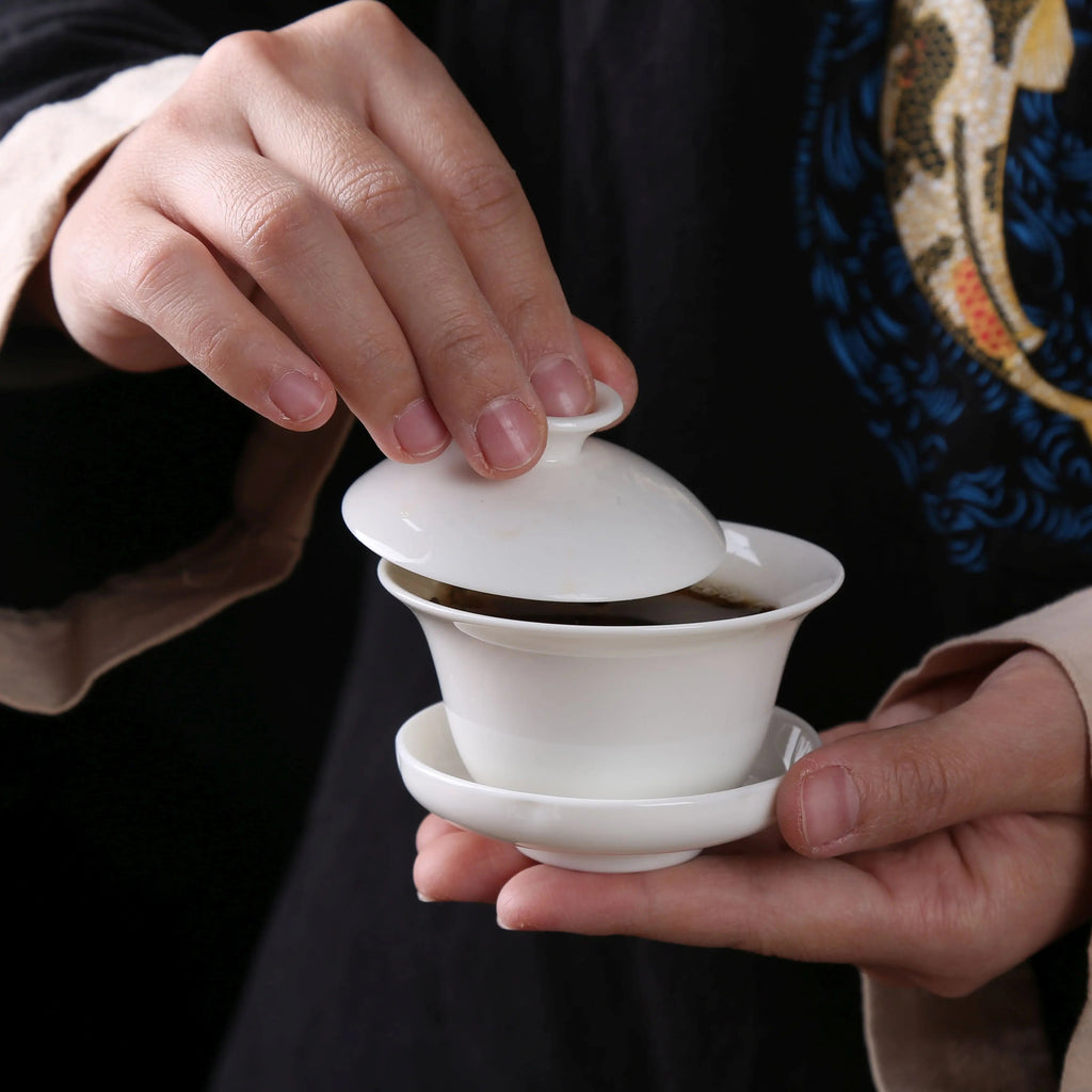 White porcelain gaiwan being used for gongfu tea brewing